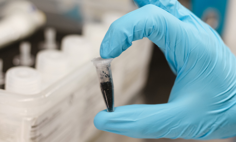 Lab Analyst Holding One Vial of Dry Calibration Standards